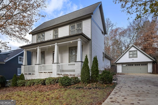 view of front of home featuring a porch, a garage, and an outdoor structure