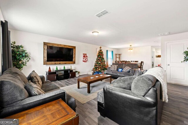 living room featuring dark wood-type flooring