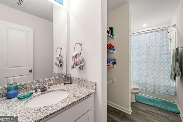 bathroom featuring hardwood / wood-style floors, vanity, and toilet