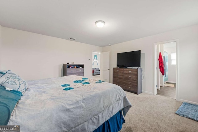 carpeted bedroom featuring connected bathroom