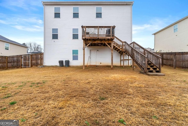 back of house featuring a yard and a wooden deck