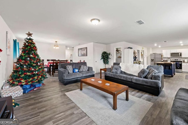 living room featuring hardwood / wood-style flooring and a chandelier