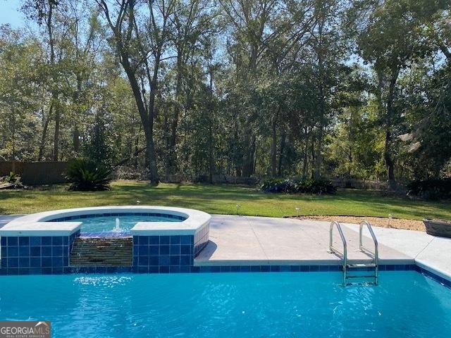 view of swimming pool with a yard and pool water feature