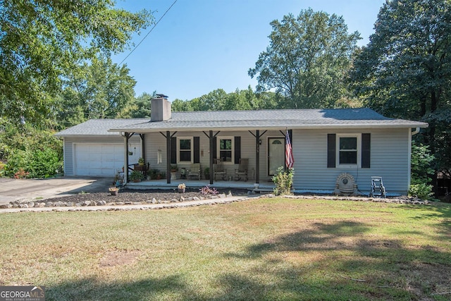 ranch-style home with a front lawn, covered porch, and a garage