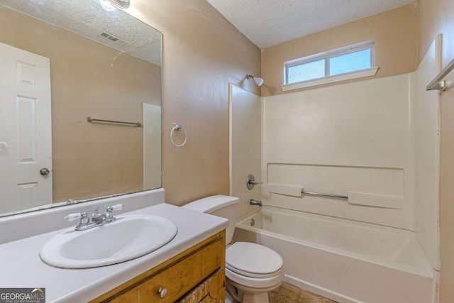 full bathroom with vanity, toilet, a textured ceiling, and bathing tub / shower combination