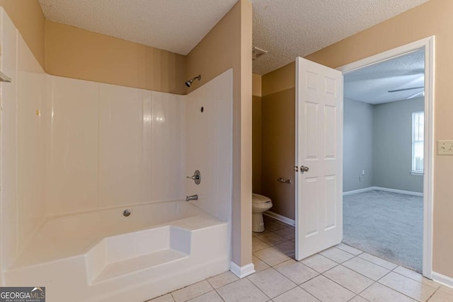 bathroom featuring bathtub / shower combination, a textured ceiling, ceiling fan, tile patterned flooring, and toilet