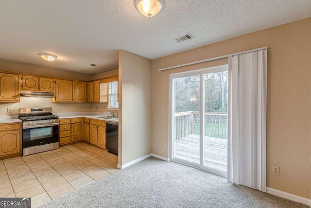 kitchen with gas range, sink, black dishwasher, light colored carpet, and a textured ceiling