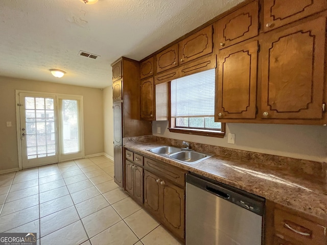 kitchen featuring sink, stainless steel dishwasher, white refrigerator, a textured ceiling, and light tile patterned floors