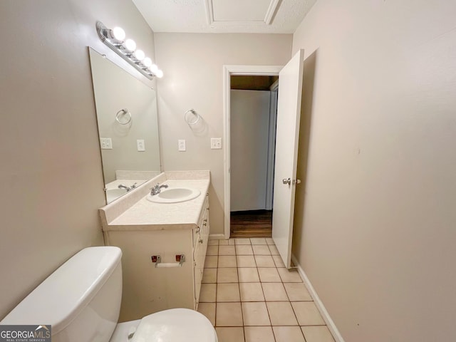 bathroom with tile patterned floors, vanity, toilet, and a textured ceiling