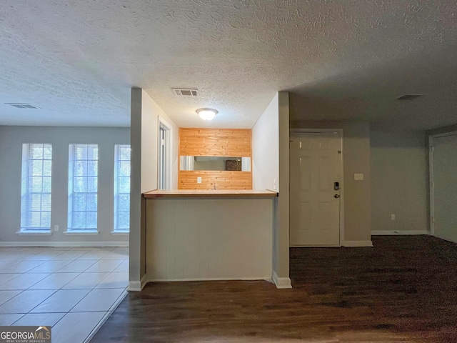 kitchen featuring hardwood / wood-style flooring, a textured ceiling, and tasteful backsplash