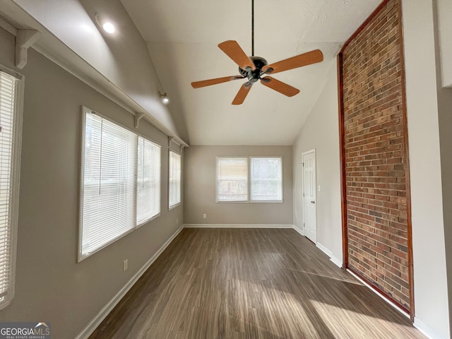 empty room featuring dark hardwood / wood-style floors, high vaulted ceiling, and ceiling fan