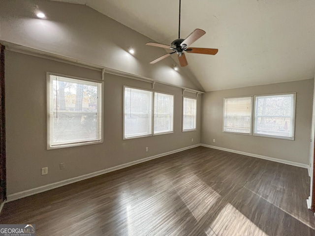 spare room featuring ceiling fan, lofted ceiling, and dark wood-type flooring