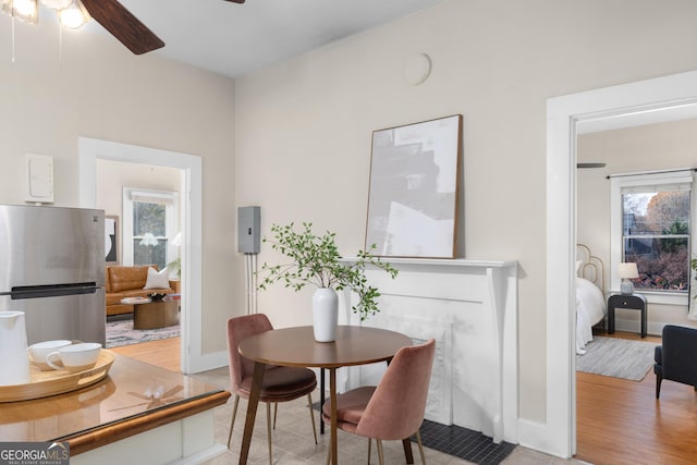 tiled dining area featuring ceiling fan