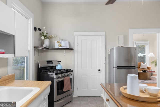 kitchen featuring ceiling fan, white cabinetry, sink, and appliances with stainless steel finishes