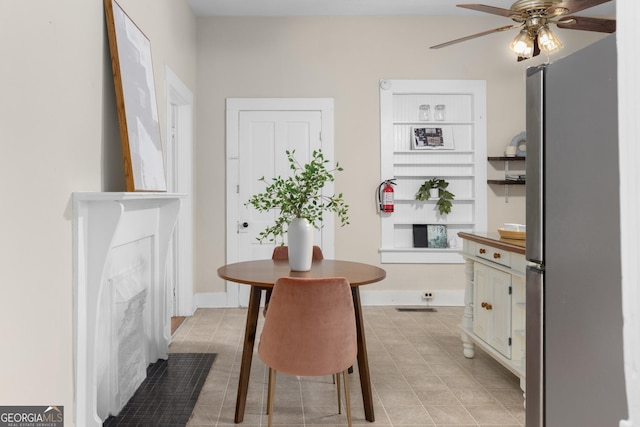 dining space featuring ceiling fan and light tile patterned floors