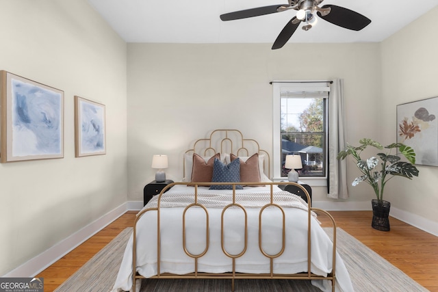 bedroom featuring ceiling fan and hardwood / wood-style floors