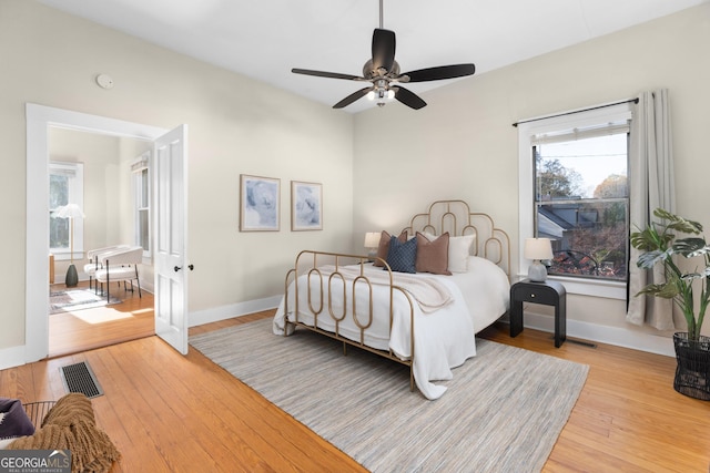 bedroom with light wood-type flooring and ceiling fan