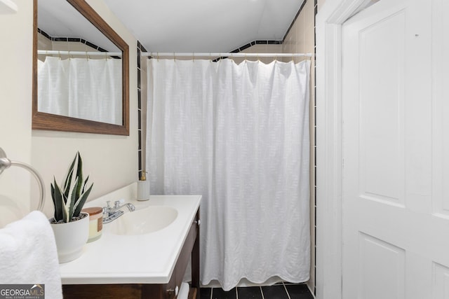 bathroom with tile patterned flooring, a shower with curtain, and vanity