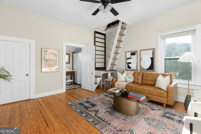 living room featuring ceiling fan and wood-type flooring