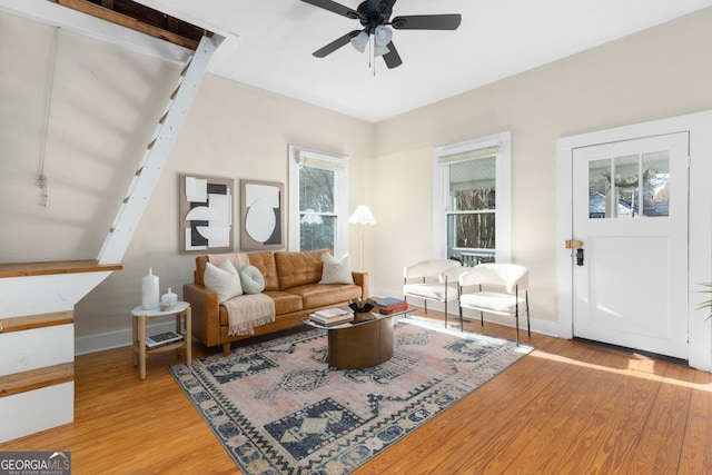 living room with a healthy amount of sunlight, ceiling fan, and light hardwood / wood-style floors