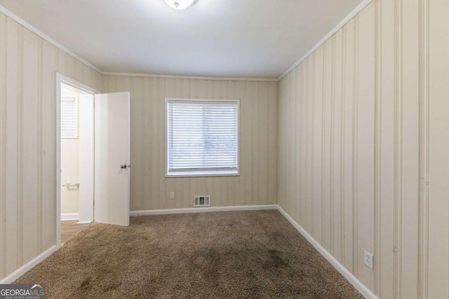 empty room with carpet and crown molding