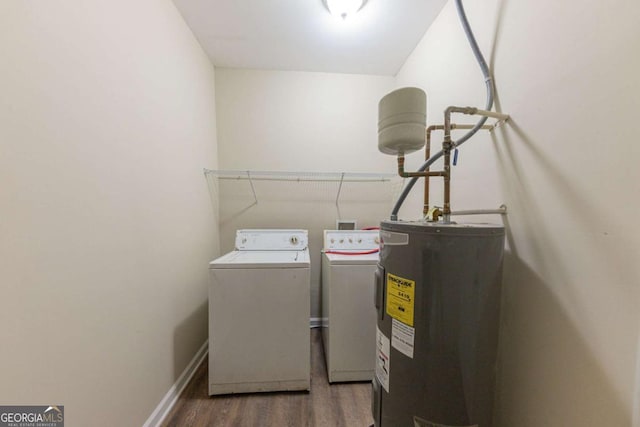 washroom featuring dark hardwood / wood-style flooring, electric water heater, and separate washer and dryer