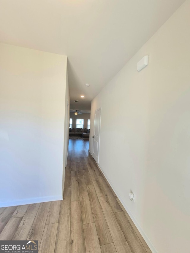 corridor with light wood-type flooring