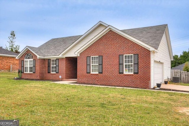 view of front of house featuring cooling unit, a garage, and a front yard