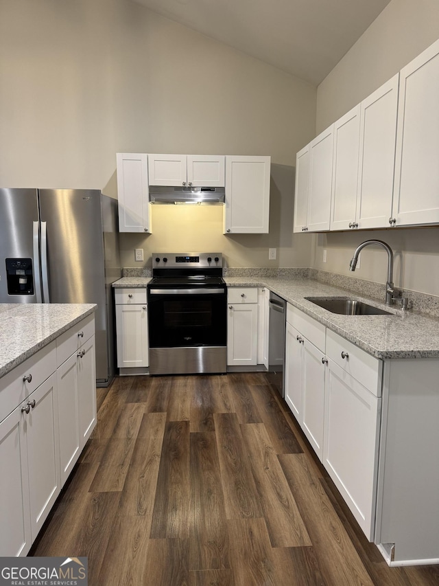 kitchen with stainless steel appliances, white cabinetry, dark wood-type flooring, and sink