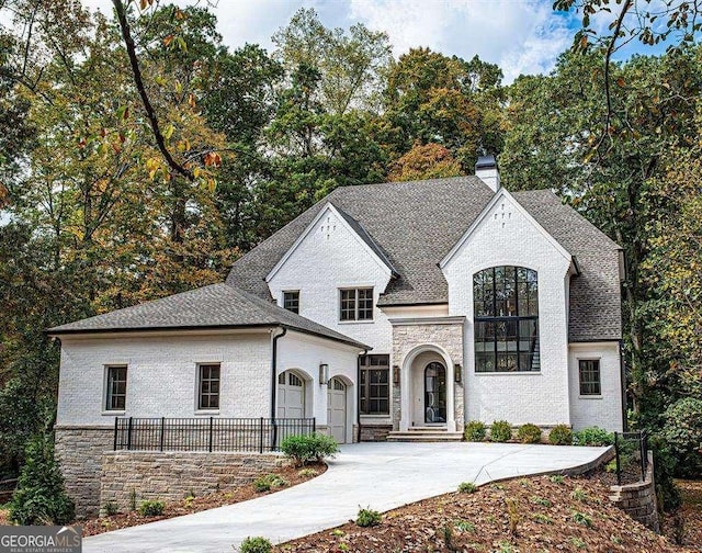 french provincial home with a garage