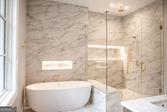 bathroom featuring plenty of natural light, shower with separate bathtub, and tile walls