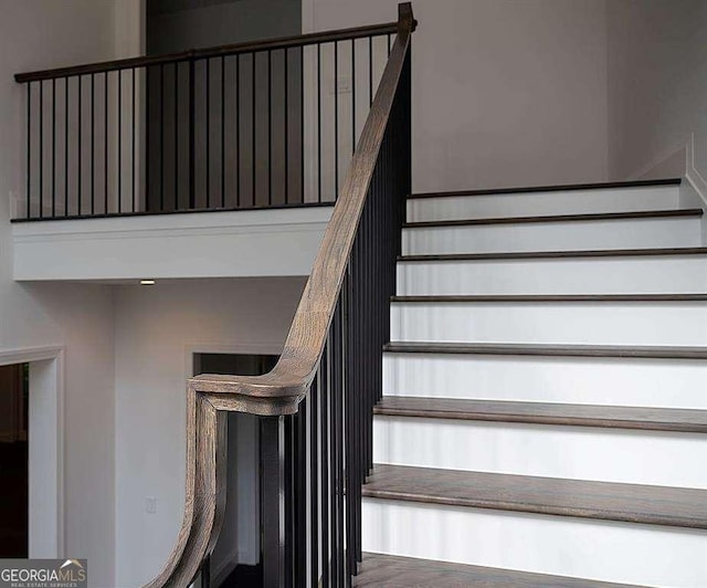 staircase with hardwood / wood-style flooring