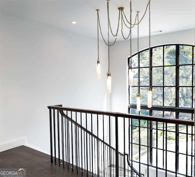 hall featuring dark hardwood / wood-style flooring and an inviting chandelier