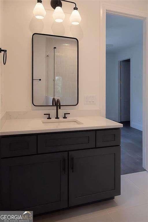 bathroom featuring tile patterned flooring and vanity