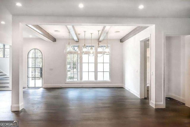 unfurnished dining area featuring beamed ceiling, dark wood-type flooring, and an inviting chandelier