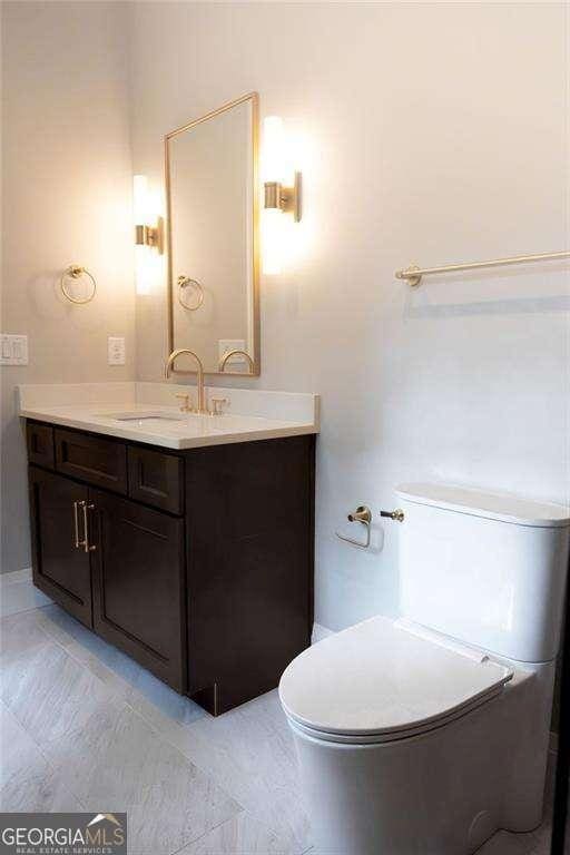 bathroom with vanity and toilet