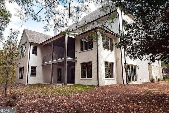 back of property with a sunroom