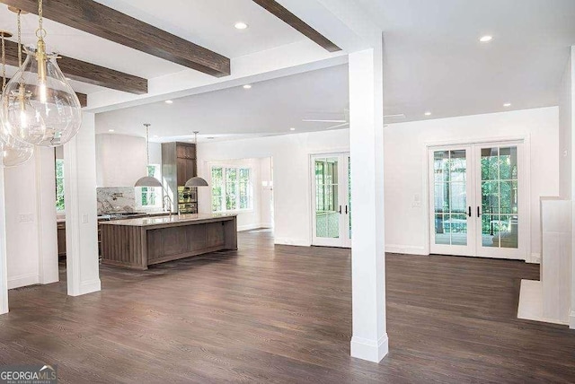 kitchen with beam ceiling, french doors, hanging light fixtures, dark hardwood / wood-style floors, and decorative backsplash