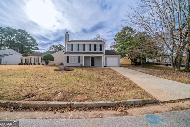 view of property featuring a garage and a front lawn