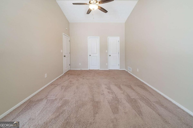 unfurnished bedroom with carpet flooring, high vaulted ceiling, and ceiling fan