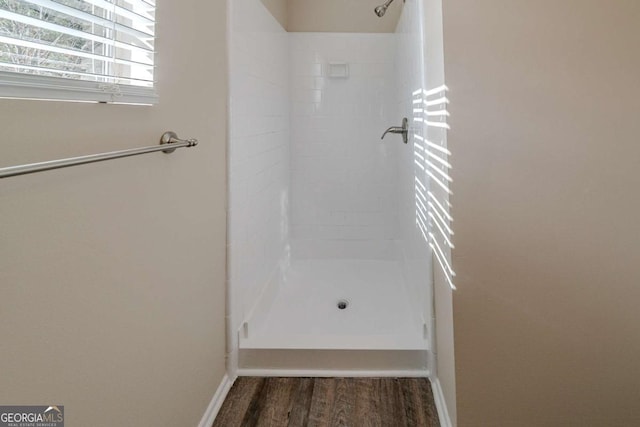 bathroom with wood-type flooring and walk in shower