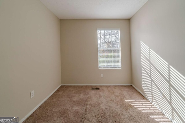 empty room featuring light carpet