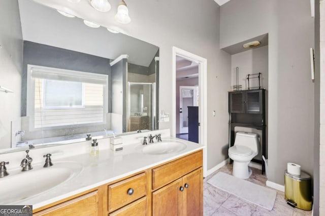 bathroom with vanity, toilet, and a shower with door