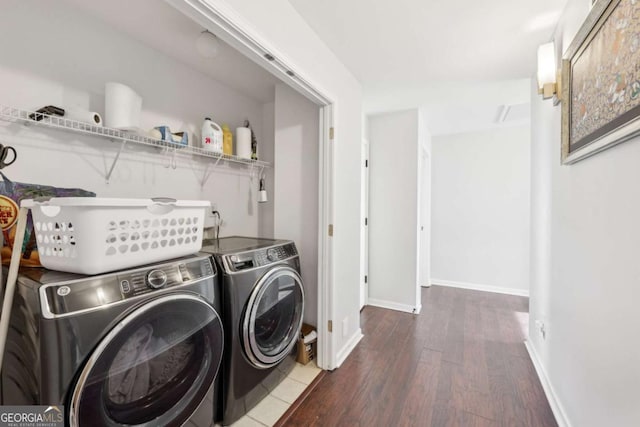 laundry area with washing machine and dryer and dark hardwood / wood-style floors