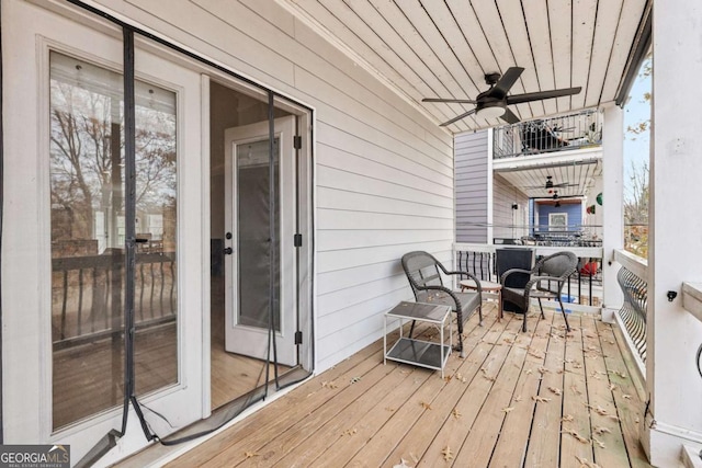 wooden deck featuring ceiling fan