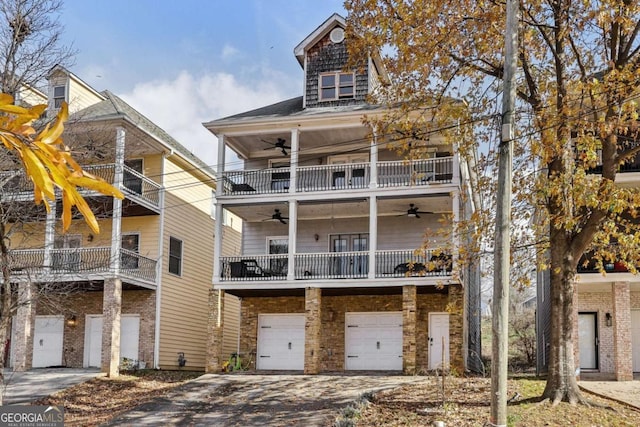 rear view of house with a balcony and a garage