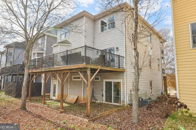 rear view of property featuring a wooden deck