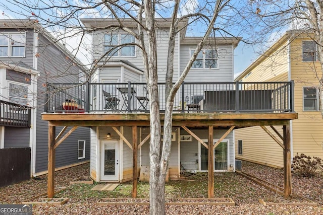 back of property featuring a wooden deck