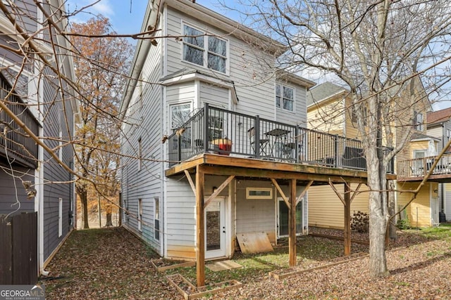 back of house with a wooden deck