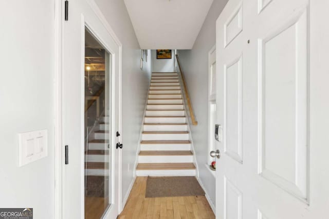 stairway with hardwood / wood-style floors